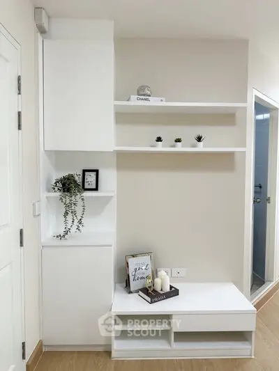 Modern minimalist interior with white shelves and decor accents in a stylish living space.