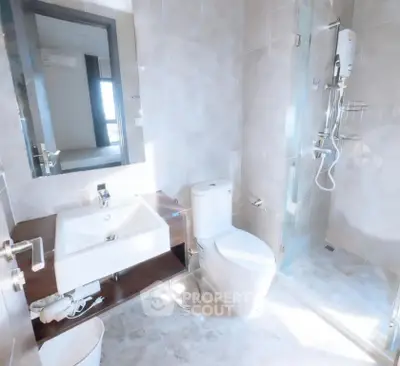 Modern bathroom with sleek fixtures and glass shower enclosure