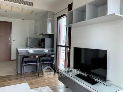 Modern open-plan living room with sleek kitchen and large window view.