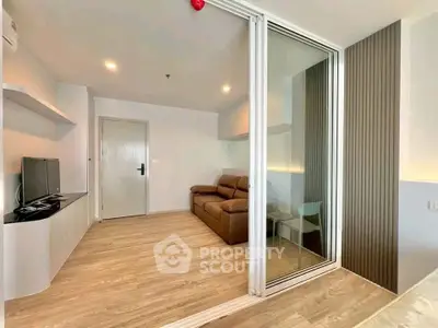 Modern living room with sleek design and glass partition in a stylish apartment.