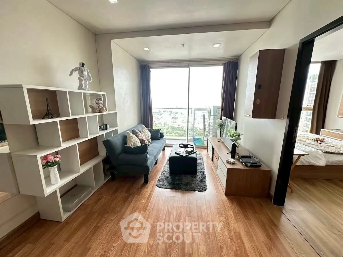 Stylish living room with modern decor and large window offering a stunning view.