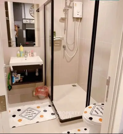 Modern bathroom with shower, sink, and stylish decor in a contemporary home.