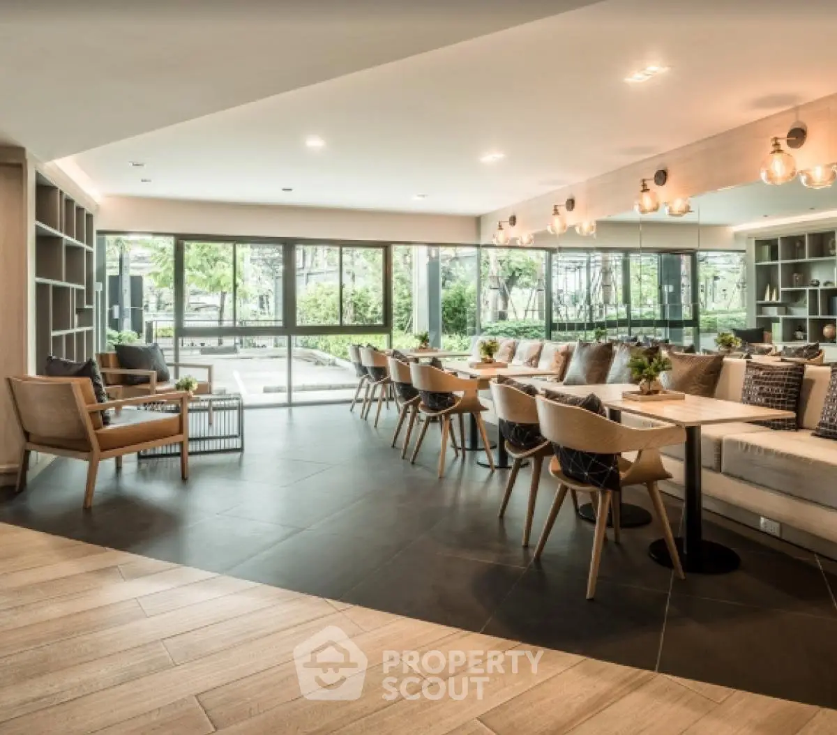 Spacious modern living area with large windows and stylish furniture in a luxurious real estate property.