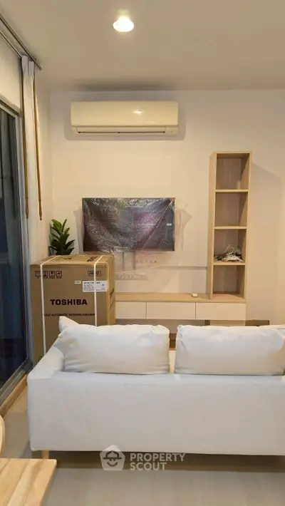 Modern living room with air conditioner and new furniture setup