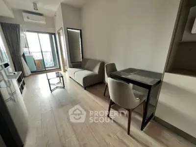Modern living room with balcony view and stylish furniture in a contemporary apartment.