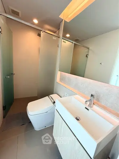 Modern bathroom with sleek fixtures and glass shower enclosure