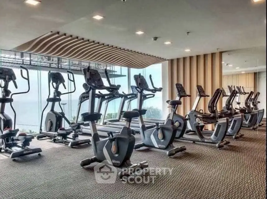 Modern gym with state-of-the-art exercise equipment and panoramic windows.