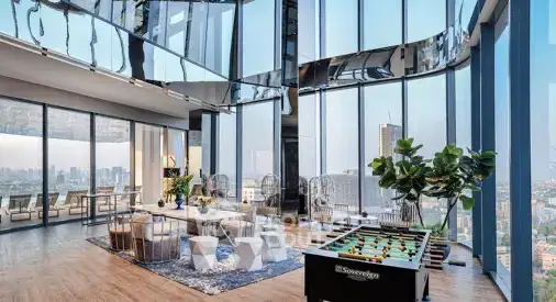 Luxurious high-rise living room with panoramic city views and modern decor.