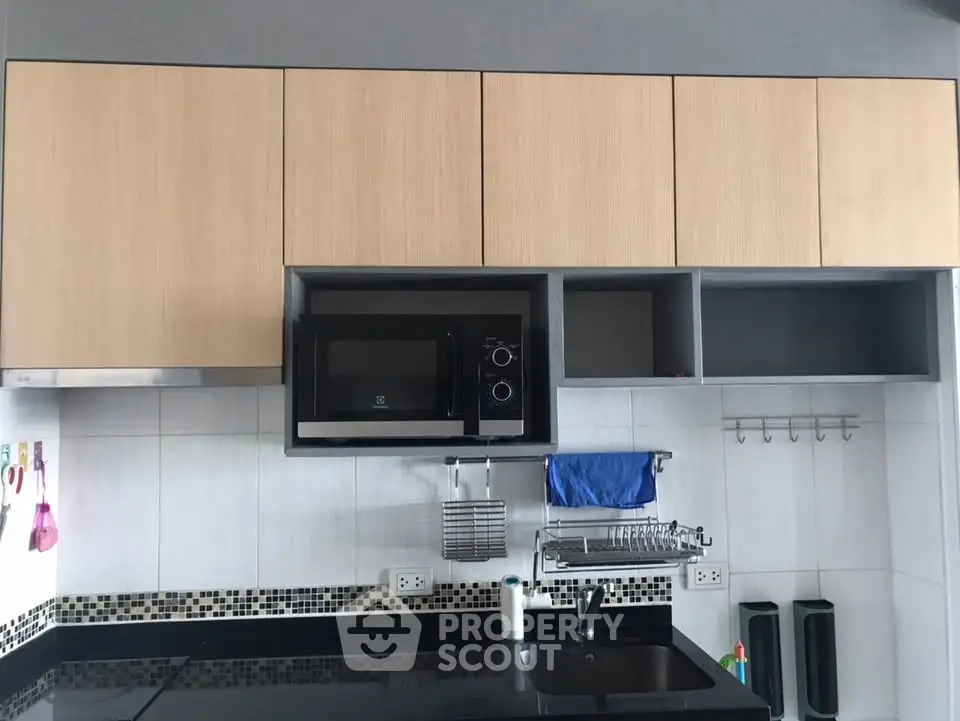 Modern kitchen with sleek cabinets and built-in microwave