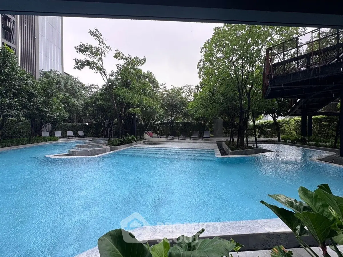 Luxurious outdoor pool area with lush greenery and modern design, perfect for relaxation and leisure.