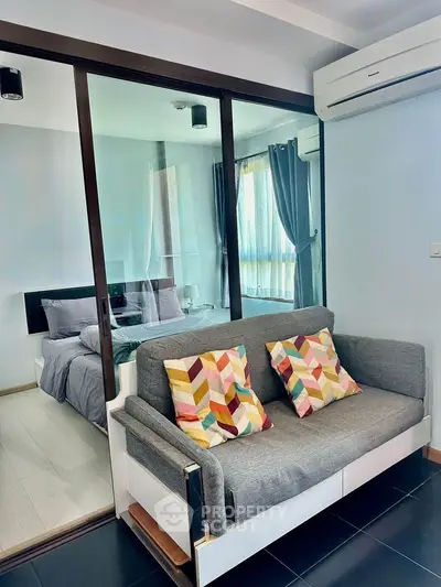 Modern compact living space with cozy sofa and stylish bedroom view