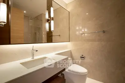 Luxurious modern bathroom with elegant marble finishes and sleek fixtures.