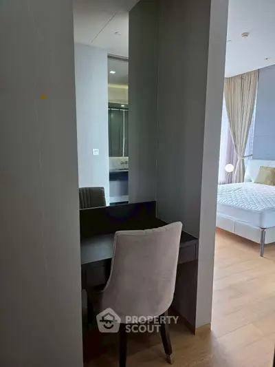 Elegant bedroom with modern decor and cozy seating area, perfect for relaxation and comfort.