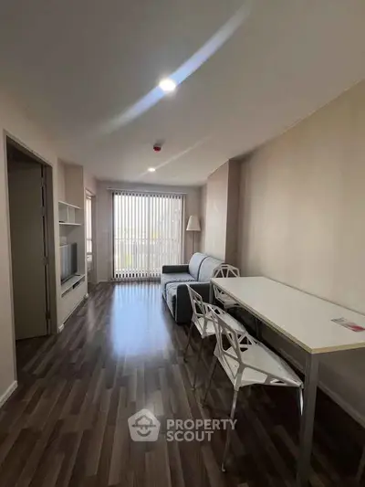 Modern living room with sleek furniture and natural light, perfect for urban living.