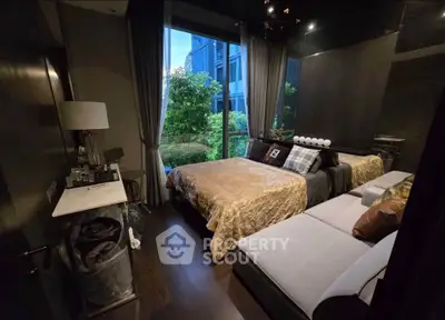 Luxurious bedroom with elegant decor and garden view, featuring plush bedding and stylish furnishings.