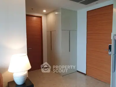 Modern apartment entrance with sleek storage and warm lighting