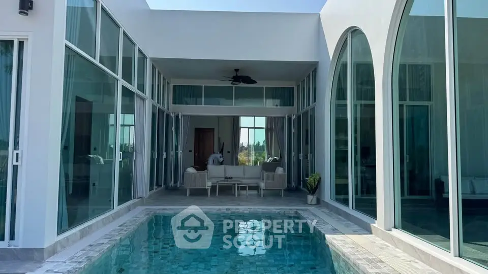 Luxurious modern villa with private pool and elegant glass architecture, perfect for serene living.