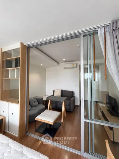 Modern living room with sliding glass doors and cozy furniture