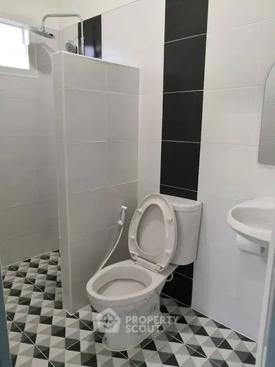 Modern bathroom with geometric tile flooring and sleek fixtures