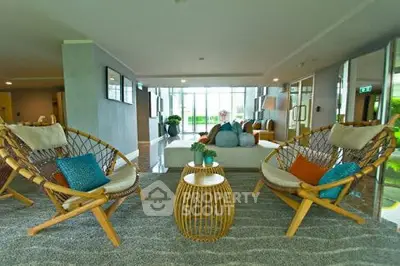 Spacious living room with stylish wicker chairs and modern decor