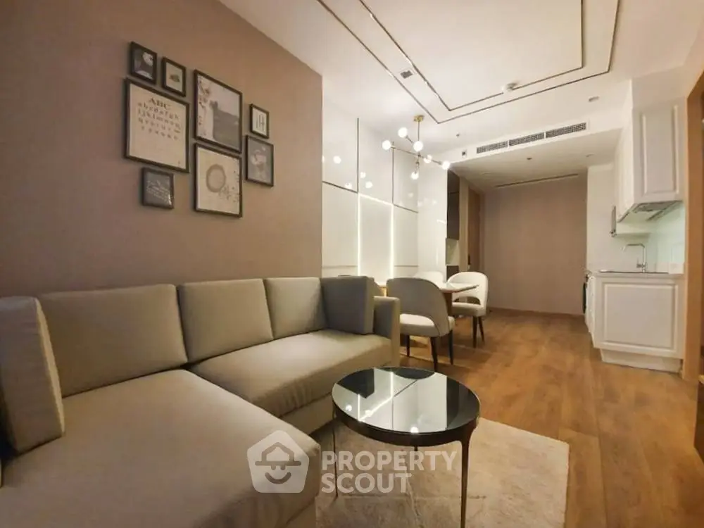 Modern living room with elegant decor and open kitchen layout in a stylish apartment.