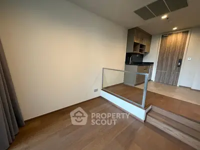 Modern apartment interior with wooden flooring and compact kitchen area