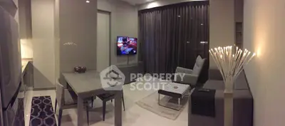 Modern living room with sleek furniture and ambient lighting, perfect for cozy evenings.