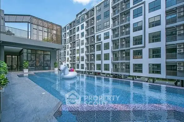 Modern apartment complex with a stylish swimming pool and unicorn float.