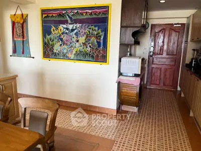Charming kitchen with vibrant wall art and wooden cabinetry, featuring a cozy dining area and tiled flooring.