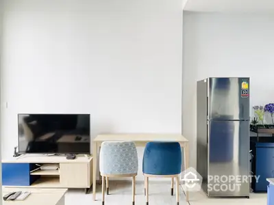 Modern minimalist living room with sleek furniture and stainless steel fridge, perfect for urban living.