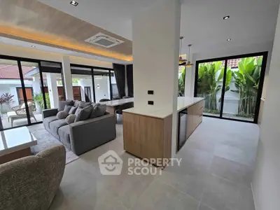 Luxurious open-plan living room with modern kitchen and garden view