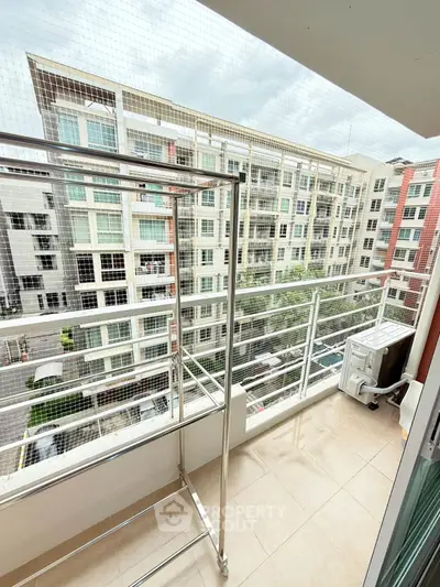 Spacious balcony with city view in modern apartment complex