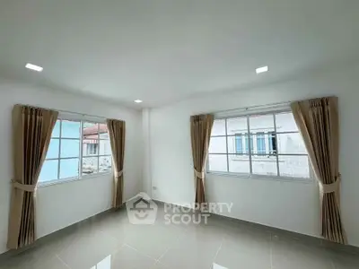 Bright and airy room with large windows and elegant curtains, perfect for natural light lovers.