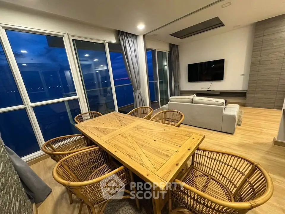 Luxurious living room with panoramic windows and stylish wooden dining set