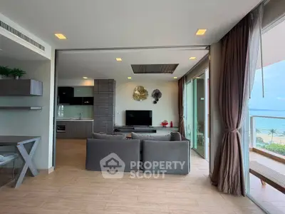 Spacious living room with ocean view and modern open kitchen layout
