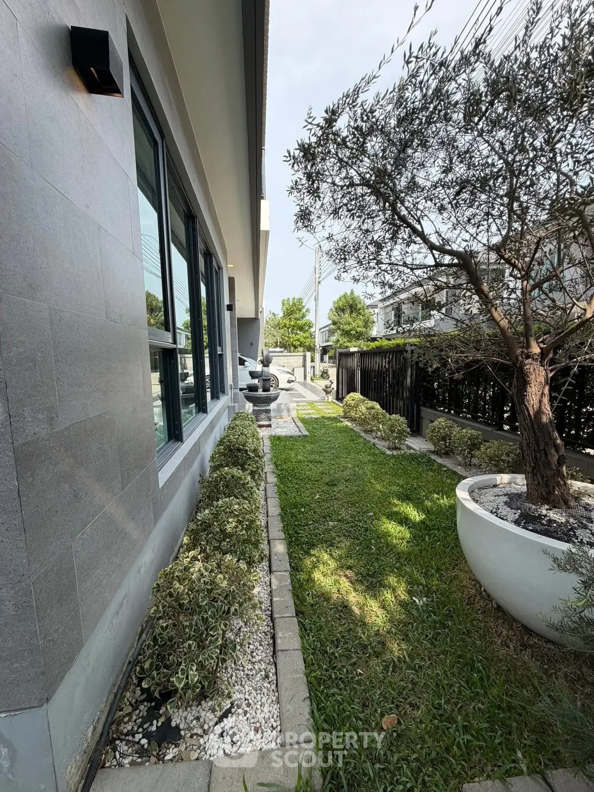 Charming garden view of modern home exterior with lush greenery and stylish landscaping.