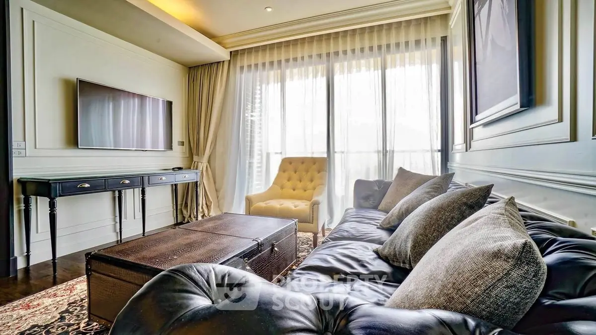 Luxurious living room with elegant decor and large windows offering natural light.