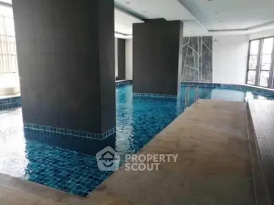 Luxurious indoor swimming pool with modern design and sleek finishes in a high-end residential building.