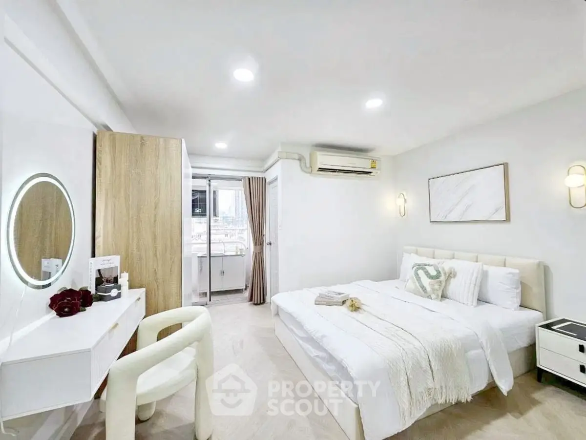 Bright and modern bedroom with stylish decor and city view.