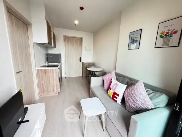 Modern compact living room with cozy decor and open kitchen layout