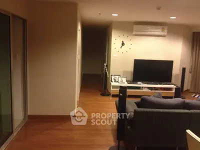 Spacious living room with modern decor and wall-mounted air conditioning unit.