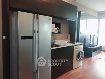 Modern kitchen with sleek appliances and open layout in stylish apartment