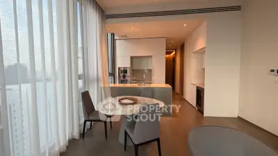 Modern open-layout kitchen with dining area and floor-to-ceiling windows in a luxury apartment.