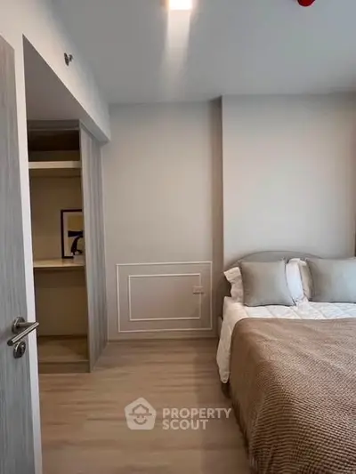 Modern bedroom with cozy bed and open closet in stylish apartment