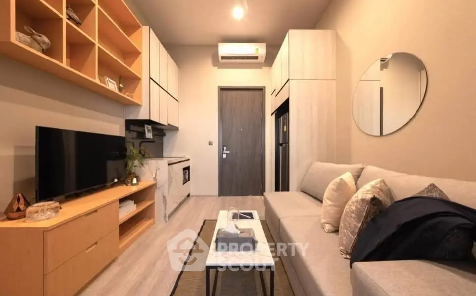 Modern living room with sleek furniture and built-in storage, featuring a cozy sofa and stylish decor.