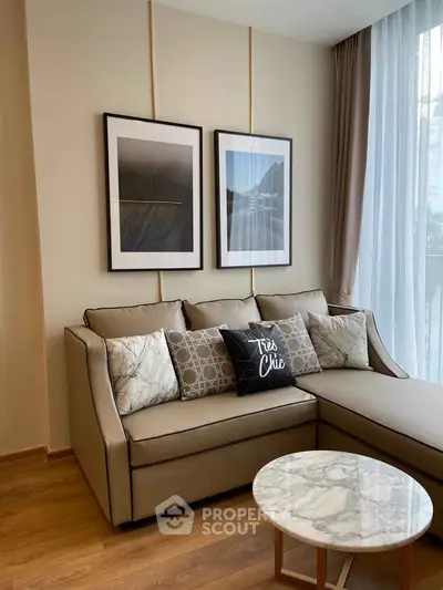 Stylish living room with modern sofa, chic decor, and elegant marble coffee table.