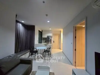 Modern apartment living room with open kitchen and stylish furniture