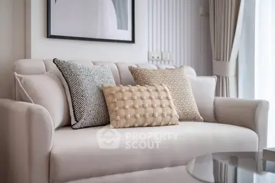 Elegant living room with plush sofa and stylish cushions in a modern apartment.