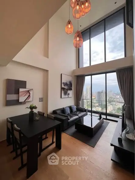 Luxurious high-rise living room with floor-to-ceiling windows and stunning city view.