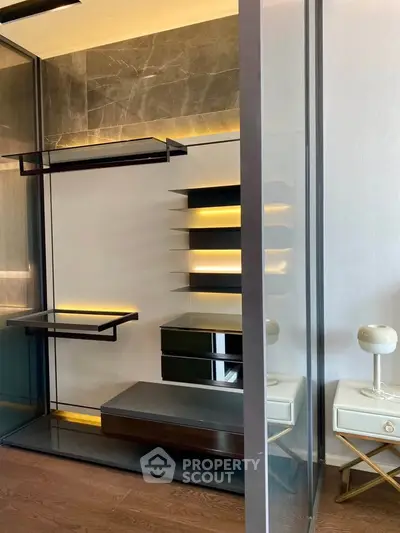 Modern interior with sleek shelving and stylish lighting in a contemporary living space.